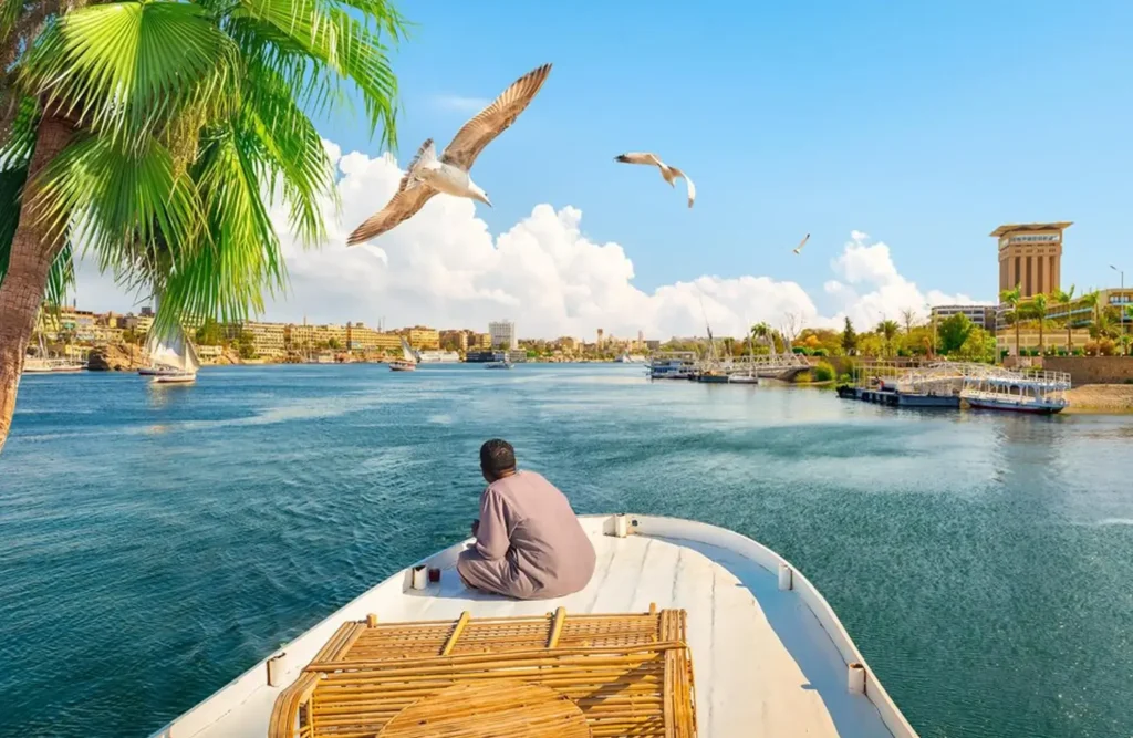 A man sitting on a boat sailing on the Nile at Aswan