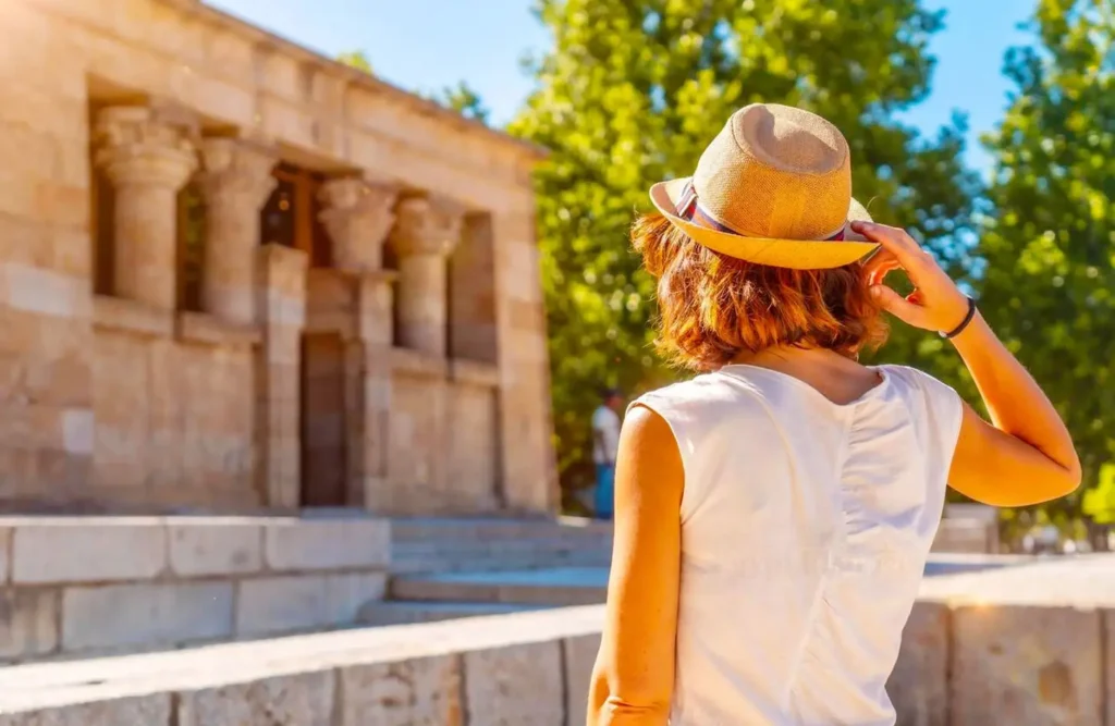 A visitor in a sun hat inside the Philae Temple